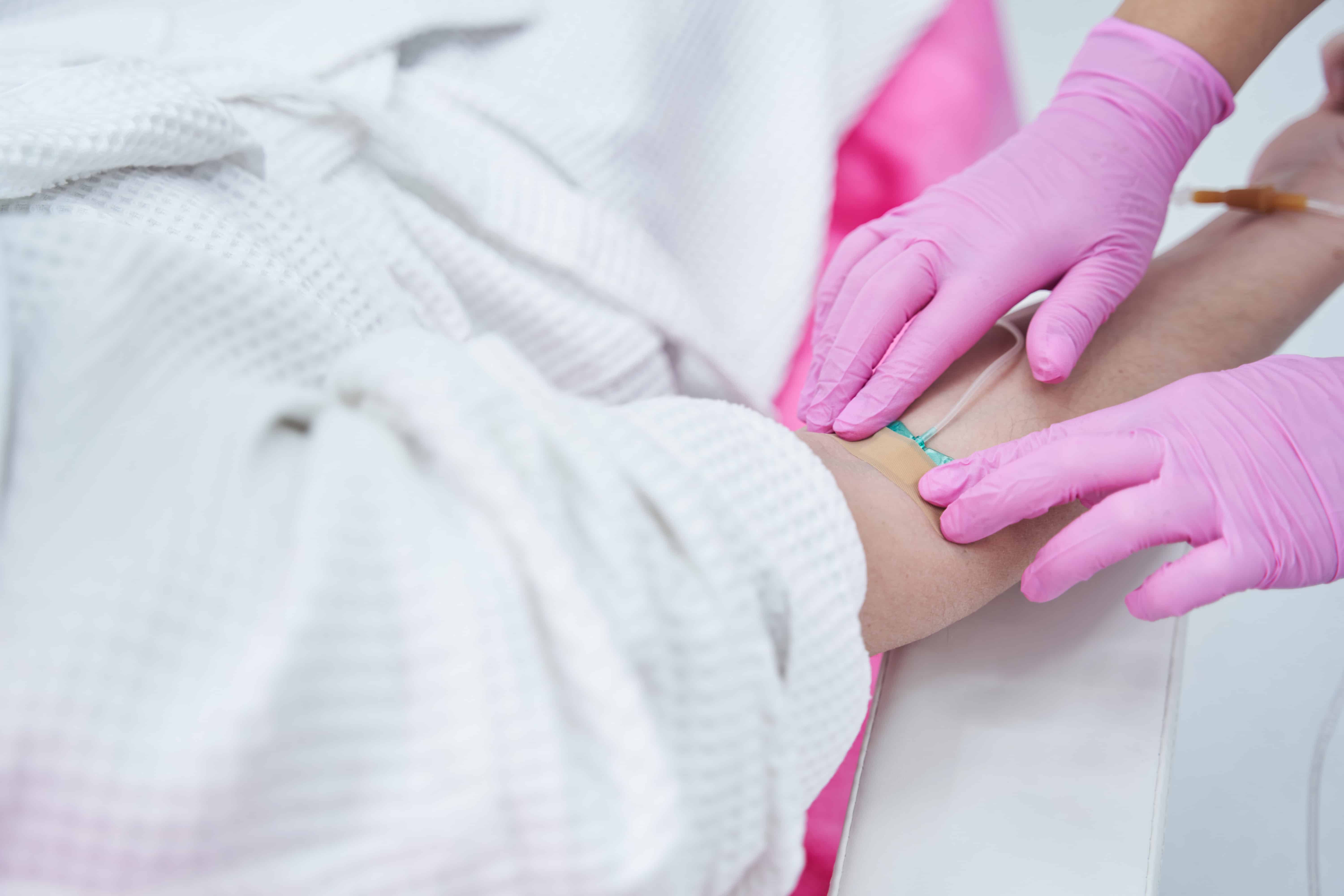 Medical worker preparing an intravenous vitamin drip treatment in beauty clinic