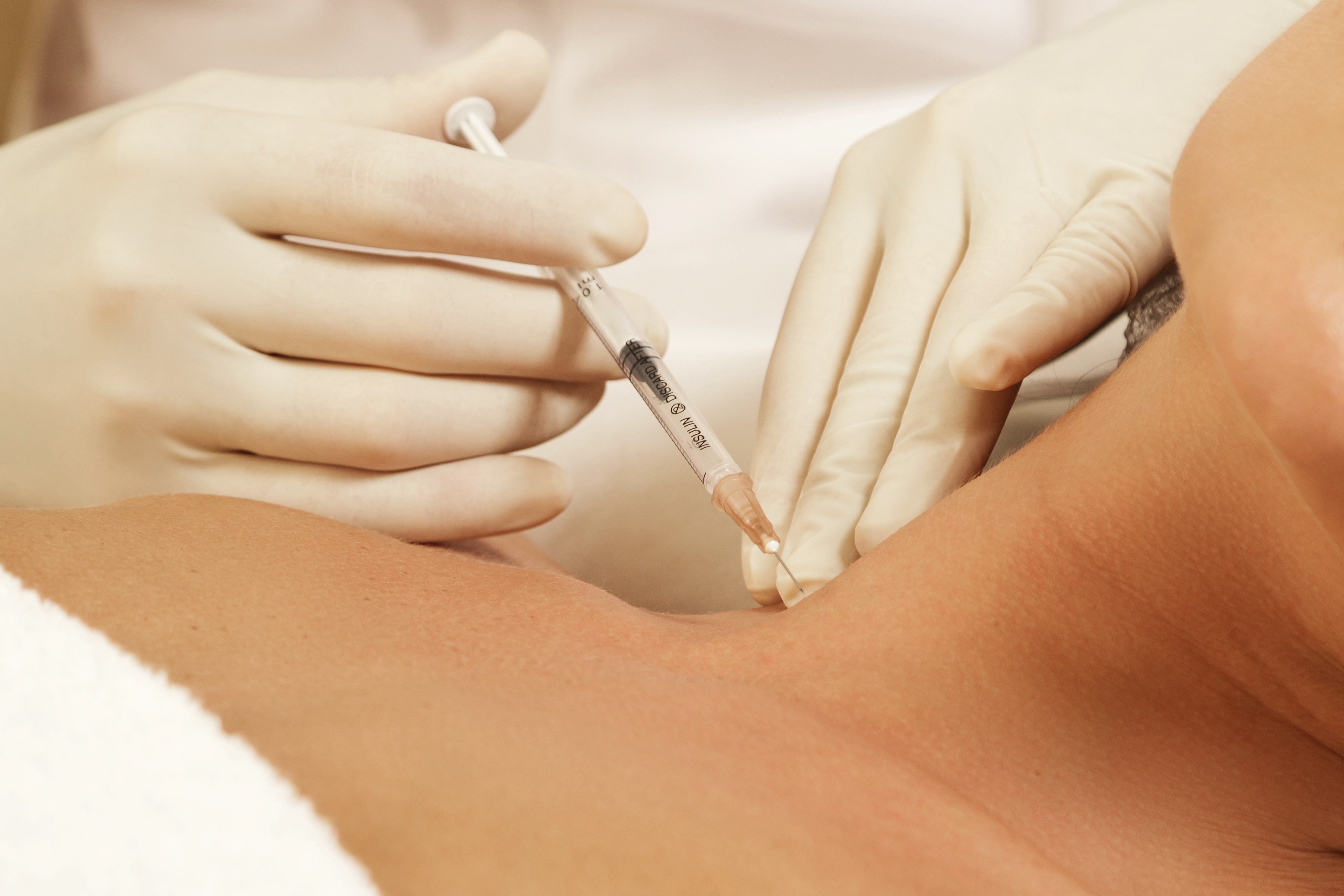 Woman in professional beauty clinic during injections for rejuvenation