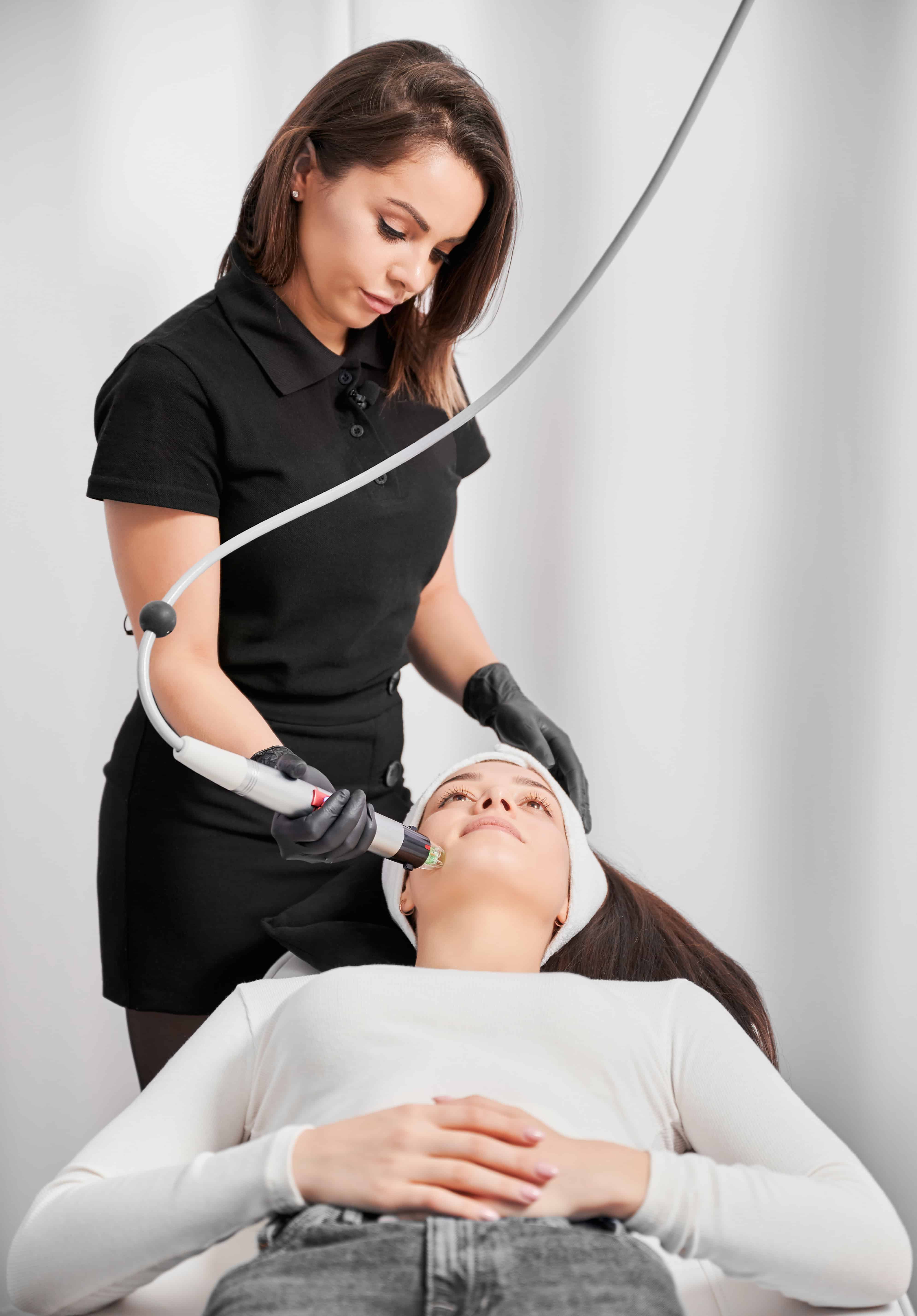 Woman getting radiofrequency microneedling treatment in clinic.